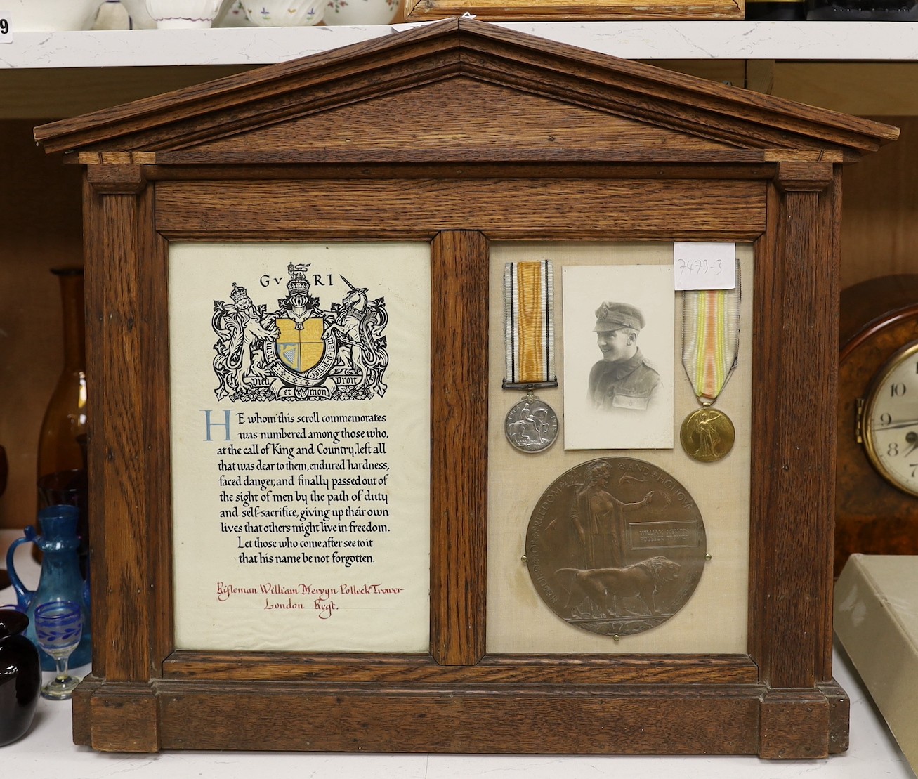 An oak framed and glazed WWI presentation group to Rifleman William Mervyn Polleck Trower, including death plaque, pair of medals and roll